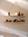 Xin Cheng, a string shelf made of screw, string, plywood and duct tape roll, holding pork bone, finial from Arthur's Pass, paper model of bookstand, found wood vase, replica of neolithic stone balls, dried coconut, dried fungi, and wood. Photo Asumi Mizuo