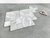 Nicky Broekhuysen, The Evolution Of Potency, 2013, engraved binary code on marble tiles with collection of raw marble piled, 121 x 195 cm