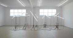 Bill Culbert, Central Station, 1991, metal lamp-stands, fluorescent tubes, electrical cable, ten elements, dimensions variable.