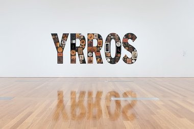 Tony Albert, Girramay people, QLD, Sorry, found kitsch objects applied to vinyl letters, 99 objects, 200 x 510 x 10 cm installed. The James C. Sourris,AM, Collection, Purchaed 2008 with funds from James C Sourris through the QAG Foundation