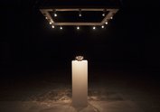Filip Gilissen (Knowing Me Knowing You, 2012, intervention, private phone number of Răzvan Ion placed outside main venue, synthetic golden phone on pedestal displayed in the darkened gallery space with spotlights). Photo: Sorin Florea