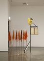 Brydee Rood and Harpreet Singh, Between Worlds, 2015, flags; Sam Thomas, New World, 2016, oil on brass, frame, steel, welding mask, artificial bananas, plastic icicles